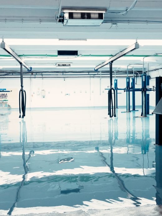 Empty car repair garage with hydraulic lifts and shiny epoxy floor Empty car repair garage with hydraulic lifts and shiny epoxy floor